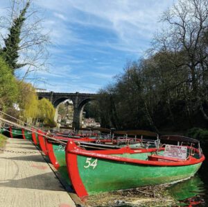 moored up rowing boats in Knaresborough in front of the viaduct